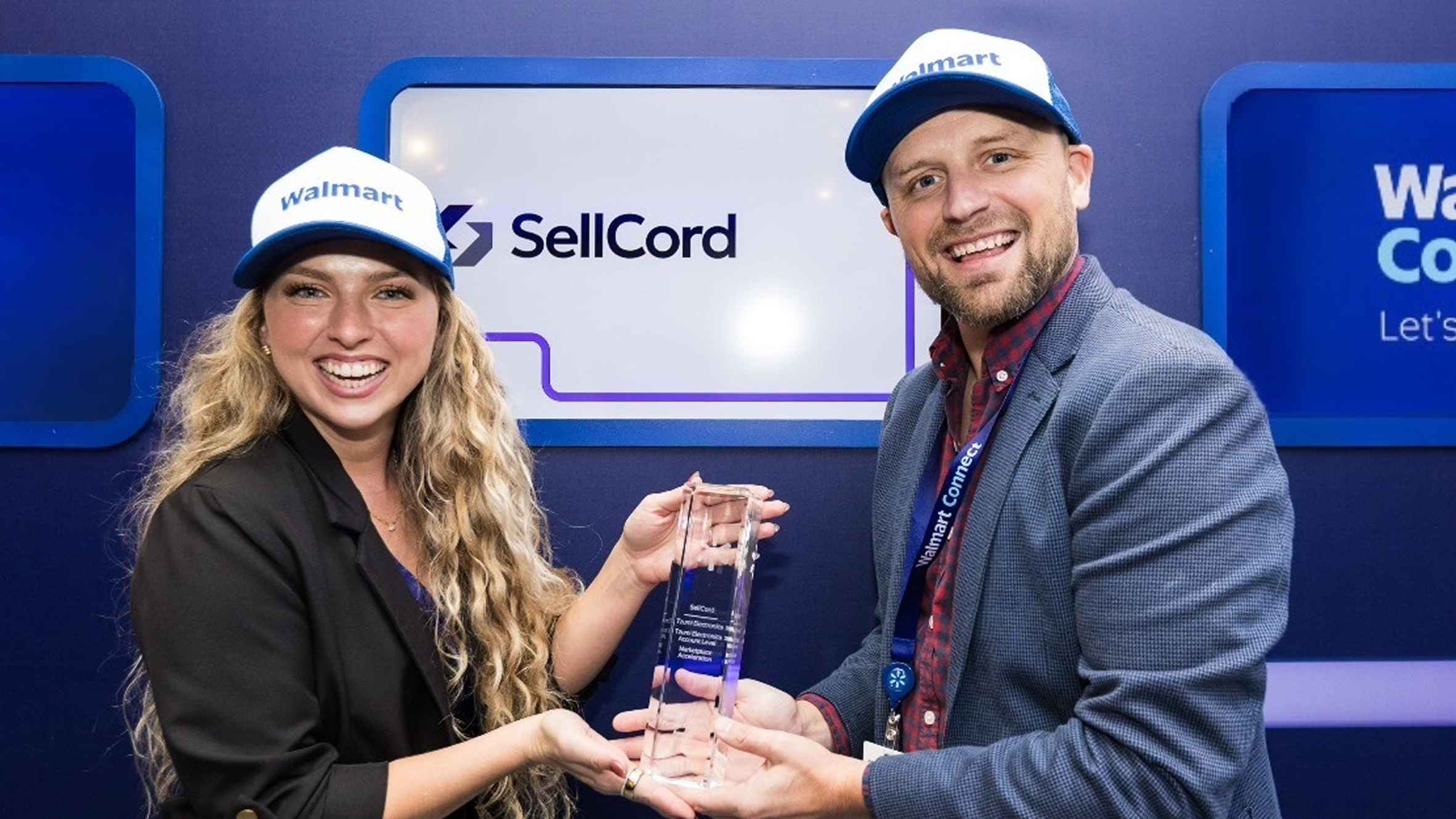 A woman and a man holding an award