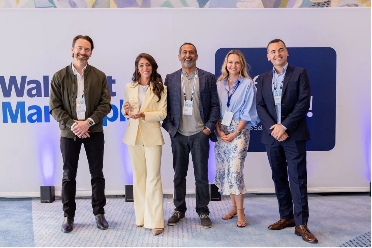 Group of people with one holding an award